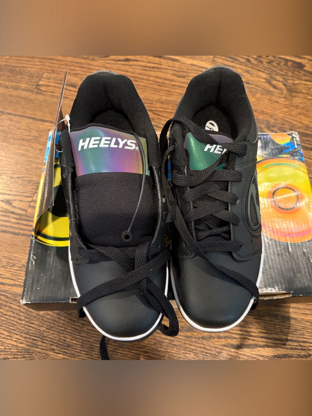 Brand new with tags. Heelys Black Sneakers with Iridescent Tongue